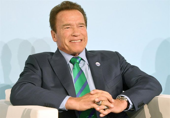 Former governor of California Arnold Schwarzenegger sits on the podium in the "B