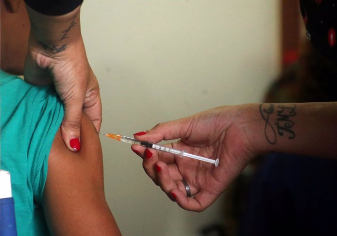 A woman is vaccinated during a campaign of vaccination against yellow fever, den
