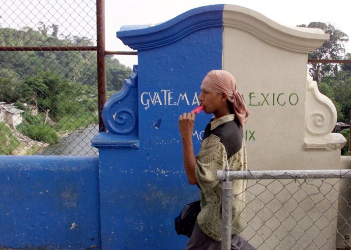 An unidentified man crosses the borderline bridge between Mexico and Guatemala i