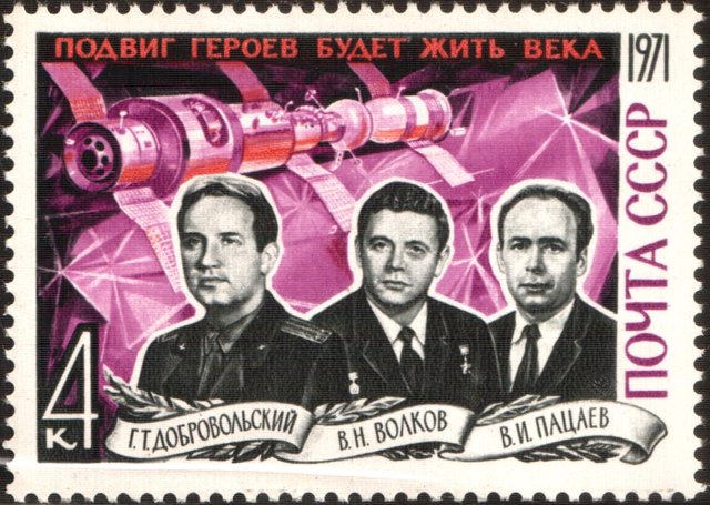 Sello con los astronautas de la Soyuz 11 con la estación Salyut 1 de fondo