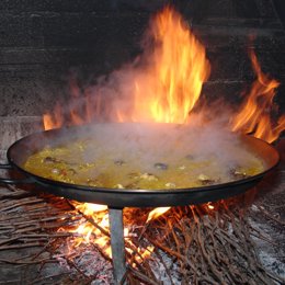La tradicional manera de hacer el arroz en El Pinós con fuego de sarmientos
