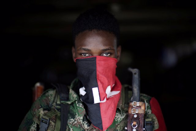 A rebel from Colombia's Marxist National Liberation Army (ELN) poses for a photo