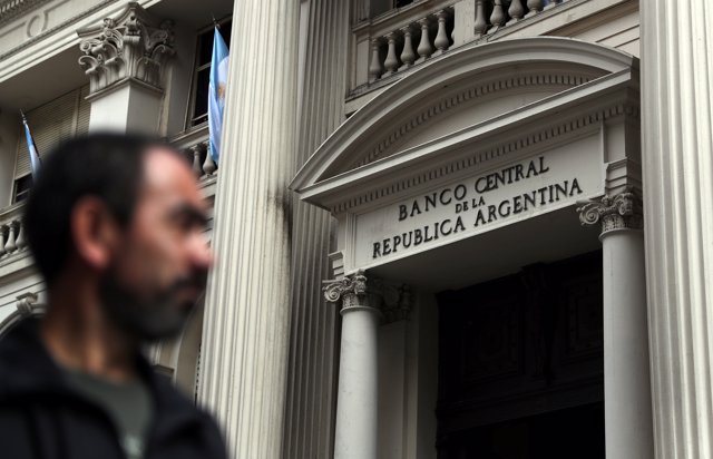 A man walks past Argentina's Central Bank in Buenos Aires' financial district, A