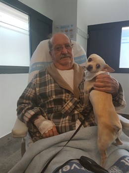 Paciente visitado por su perro en el hospital