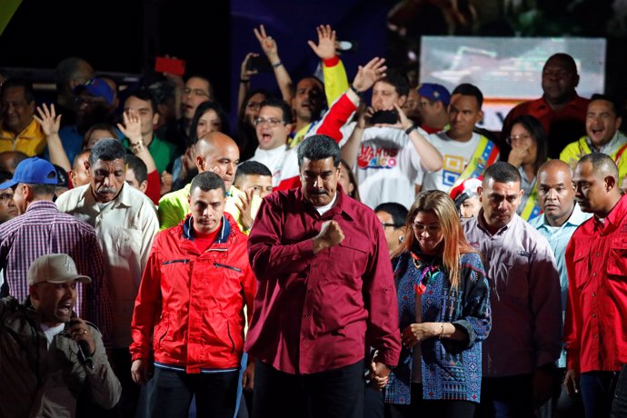 Venezuela's President Nicolas Maduro stands with supporters during a gathering a