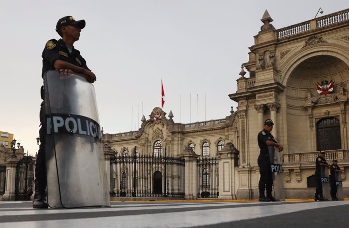 Peruvian police guard in front of the Government Palace after Peru's President P