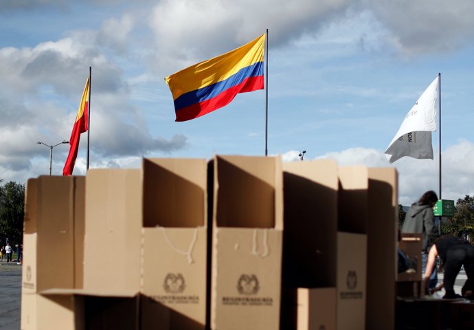 The Colombian flag is seen as people assemble voting booths ahead of the May 27 
