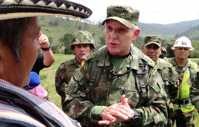 Alberto Mejia, Commander of the Colombian National Army, talks to a peasant duri