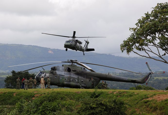 Soldiers of the Colombian Military Forces make a flyby during the army's arrival