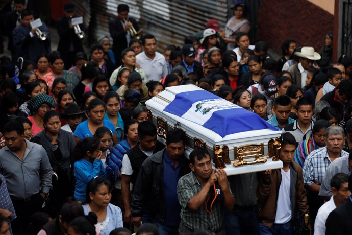 People carry the coffin of Eric Rivas, 20, who died during the eruption of the F