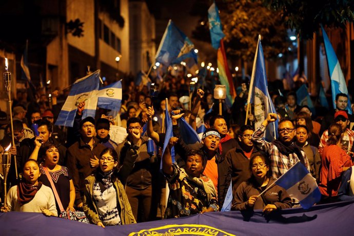 Demonstrators take part in a protest against the Guatemalan government's disaste