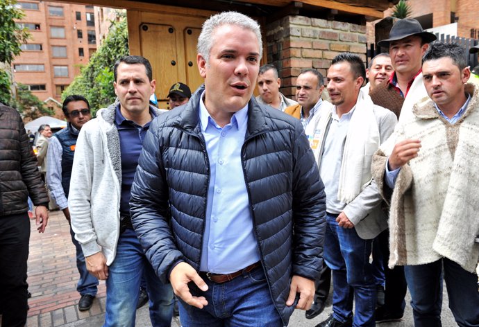 Colombian presidential candidate Ivan Duque (C) greets followers at his party's 