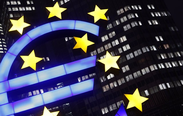 An illuminated euro sign is seen in front of the headquarters of the European Ce