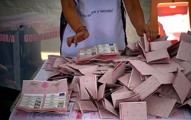 A poll worker sorts ballots during the gubernatorial election in Toluca, Mexico 