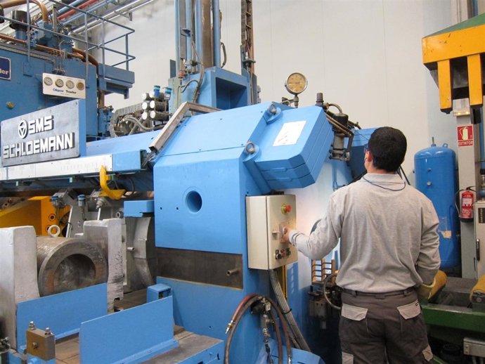 Operario manipulando una máquina en su trabajo.