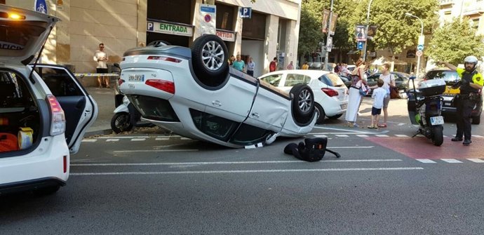 Coche volcado en el Eixample de Barcelona