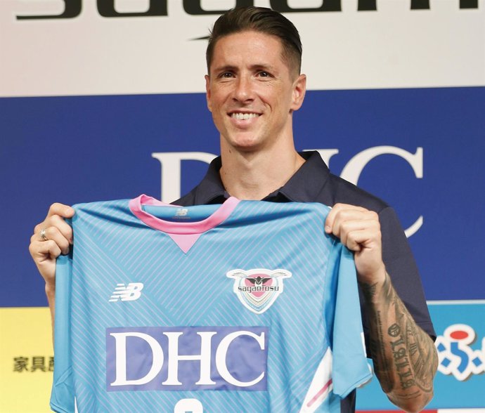Spain soccer player Fernando Torres poses with his new Sagan Tosu football club 