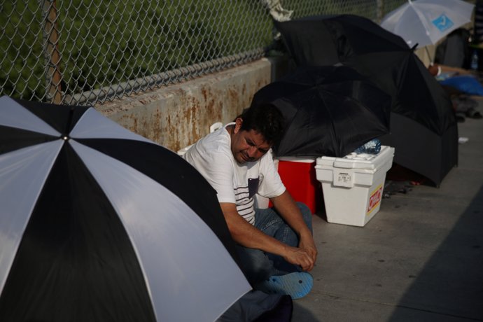 Eduardo, an asylum seeker from Guatemala, waits on the Mexican side of the Brown