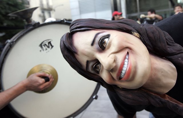 A supporter wears a mask of Argentina's first lady and presidential candidate se