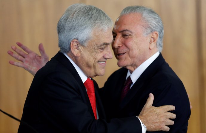 Chile's President Sebastian Pinera is greeted by Brazilian President Michel Teme