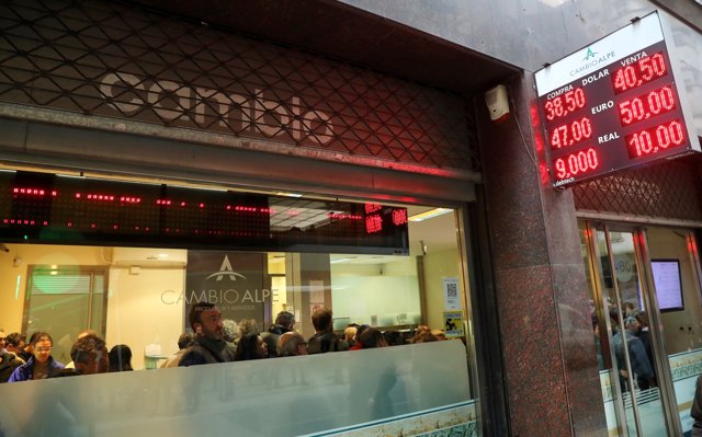 People are seen inside a currency exchange store in Buenos Aires' financial dist