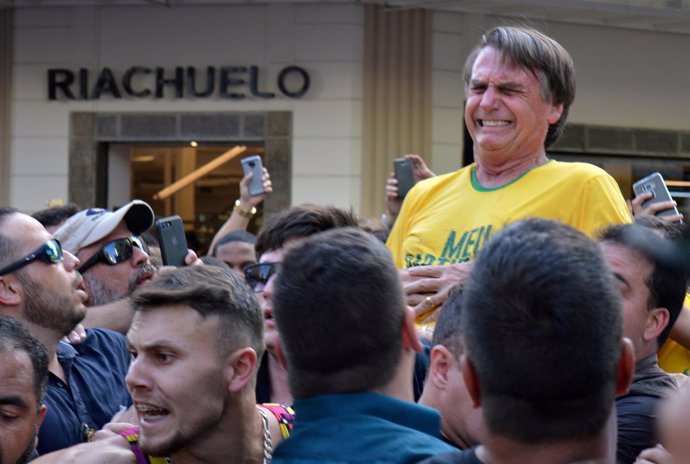 FILE PHOTO: Brazilian presidential candidate Jair Bolsonaro reacts after being s