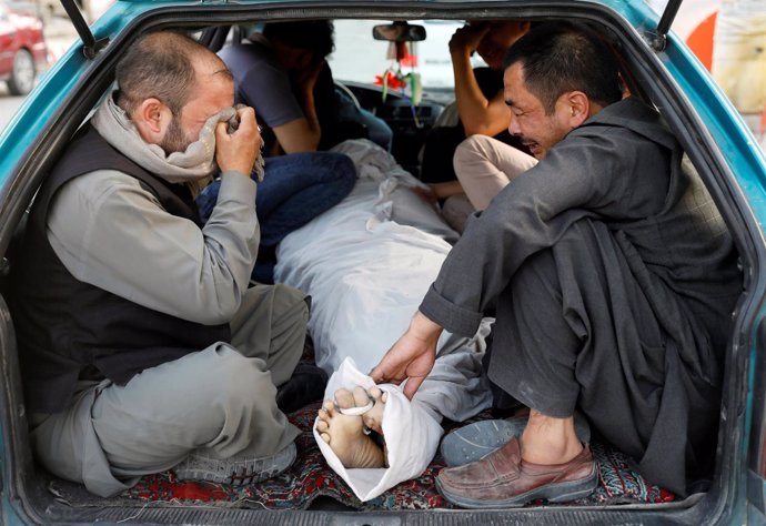 Hombres lloran a una víctima de un atentado en Kabul