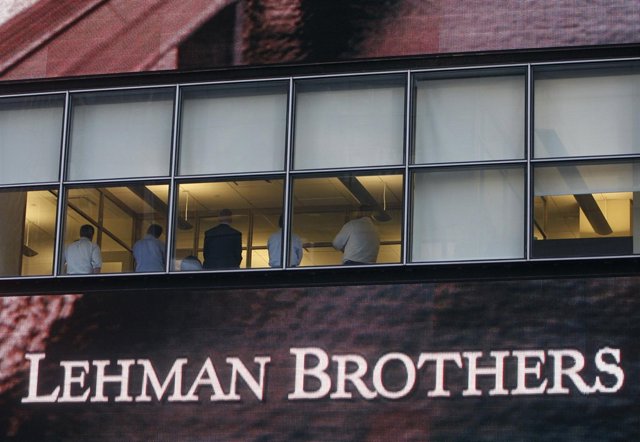 People sit in the window at the Lehman Brothers building in New York September 1