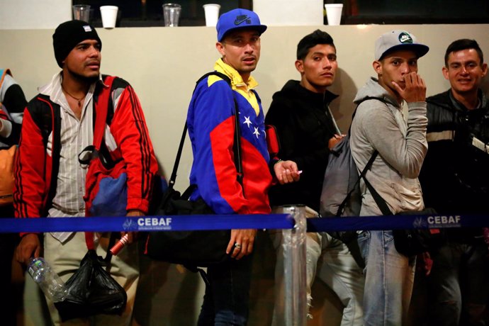 Venezuelan migrants wait at the Binational Border Service Center of Peru, on the
