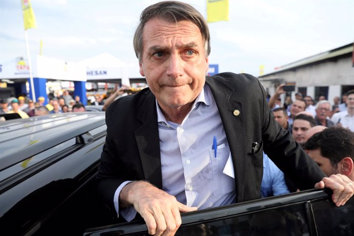 FILE PHOTO: Presidential candidate Jair Bolsonaro leaves an agribusiness fair in