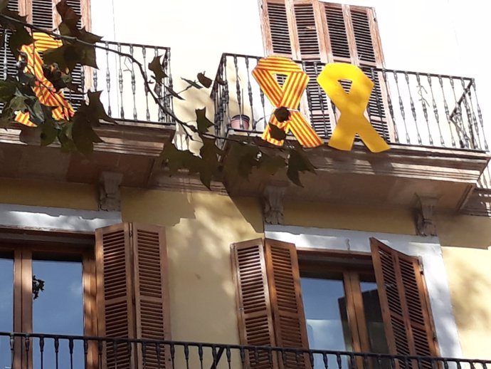 Lazo amarillo colgado en un balcón del Ayuntamiento de Palma