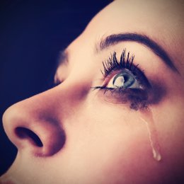 Mujer llorando y una lágrima