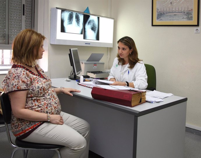 Mujer embarazada dialoga con personal médico experto en asma