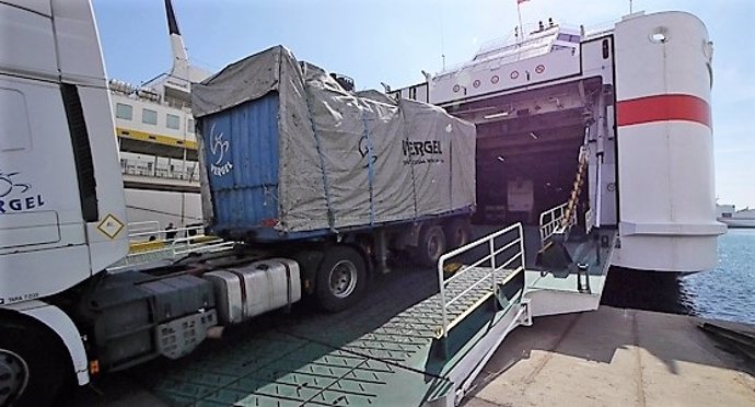 Un camión carga mercancía en un barco desde el Puerto de Almería