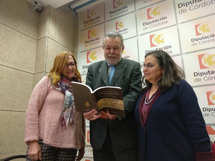 Blanco, entre Caro (izda.) y Kramer, ojea el libro