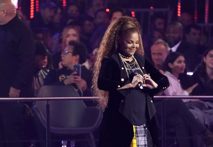 Singer Janet Jackson makes a heart symbol after receiving the Global Icon award
