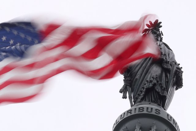 The U.S. Flag flies near the Statue of Freedom atop the U.S. Capitol in Washingt