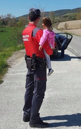 Un agente sostiene a una niña en una intervención por violencia de género.