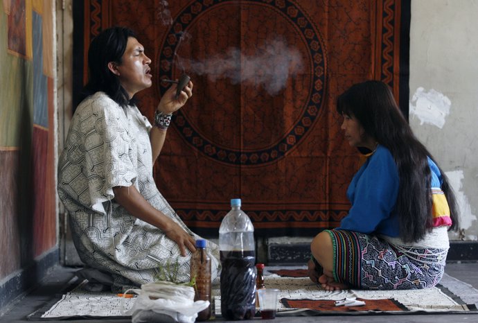 Pedro Tangoa, a shaman, performs a ritual treatment for the photographer after d