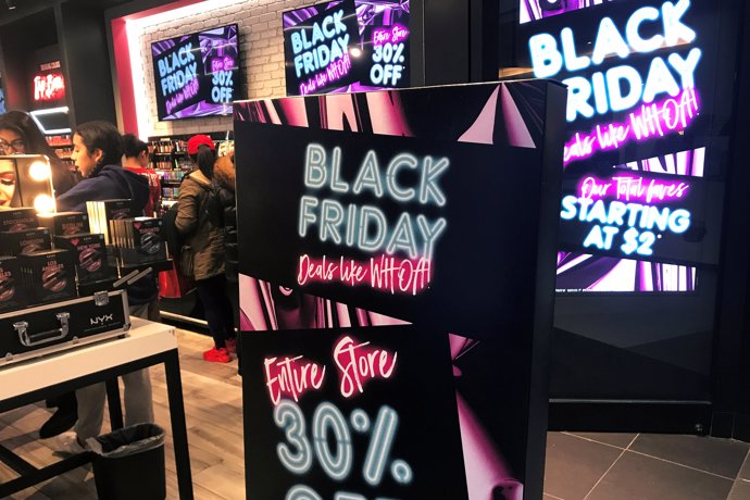 A Black Friday sale sign is displayed outside a makeup store at Roos