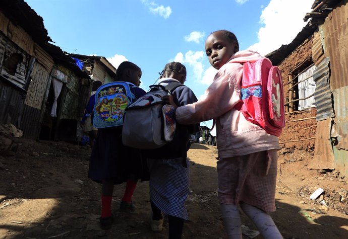 Niños con mochilas en el 'slum' de Kibera
