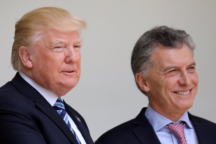U.S. President Donald Trump talks with Argentina's President Mauricio Macri duri