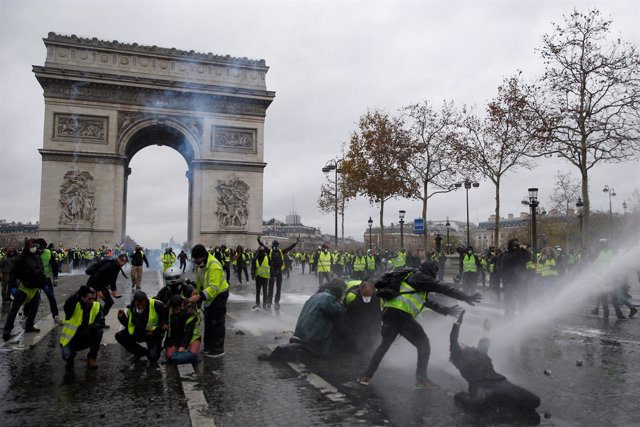 Protesters wearing yellow vests, a symbol of a French drivers' protest against h