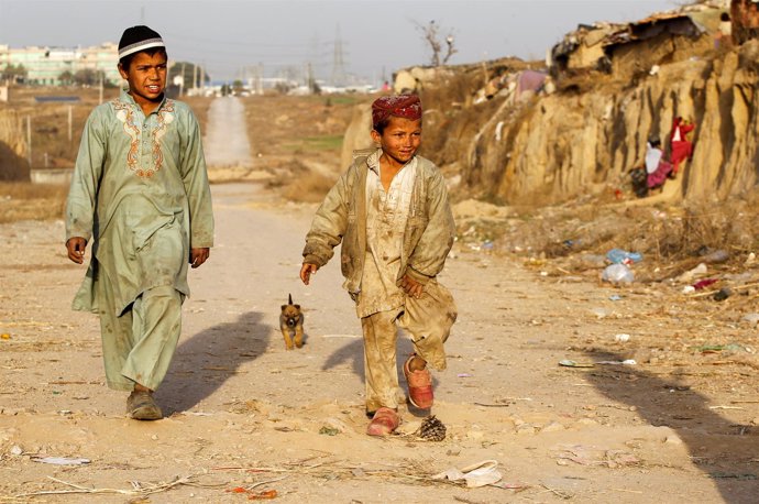 Children arrive to play with friends at an Afghan refugee camp in Islamabad, Pak