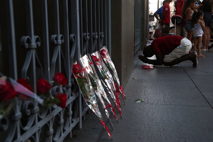 A man reacts next to flowers after a shooting at Catholic cathedral in Campinas,
