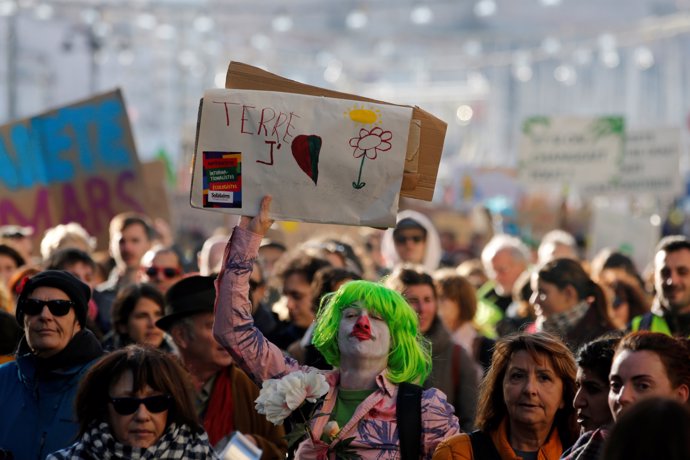 People attend a demonstration to urge politicians to act against climate change