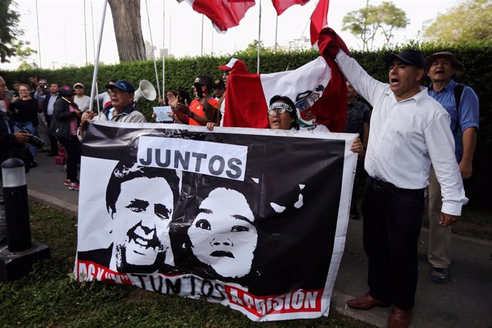 Protesters against former President Alan Garcia gather outside the residence of