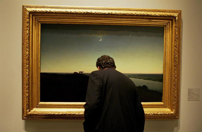 A man looks at Arjip Kuindzhi's "At night" (1905-8) during a media preview of "R