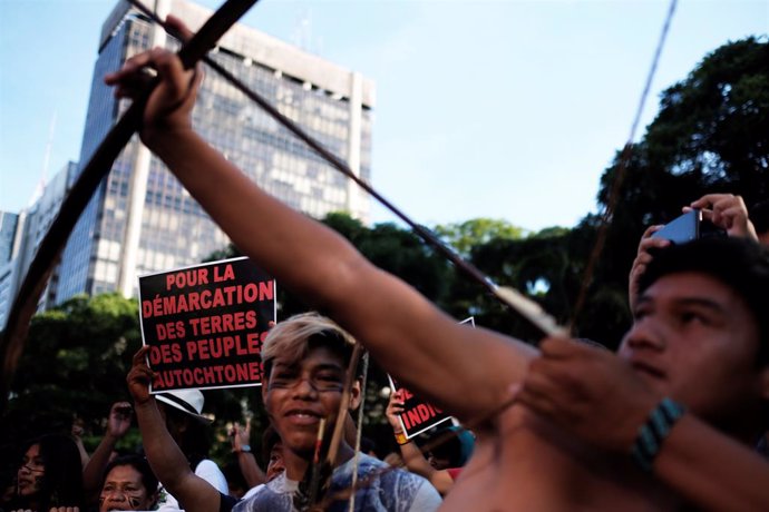 Indigenous men take part in a protest against Brazil President Jair Bolsonaro's