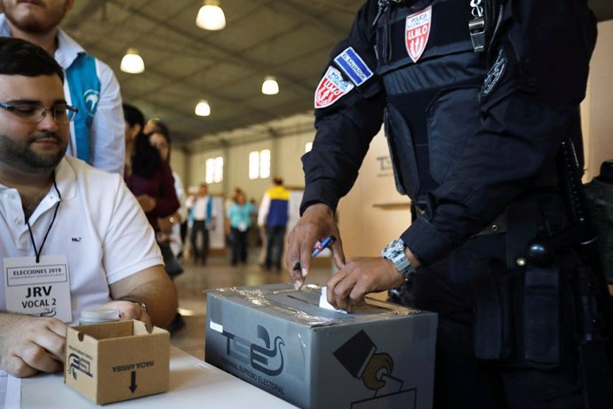 A police officer casts his vote during the presidential election in San Salvador